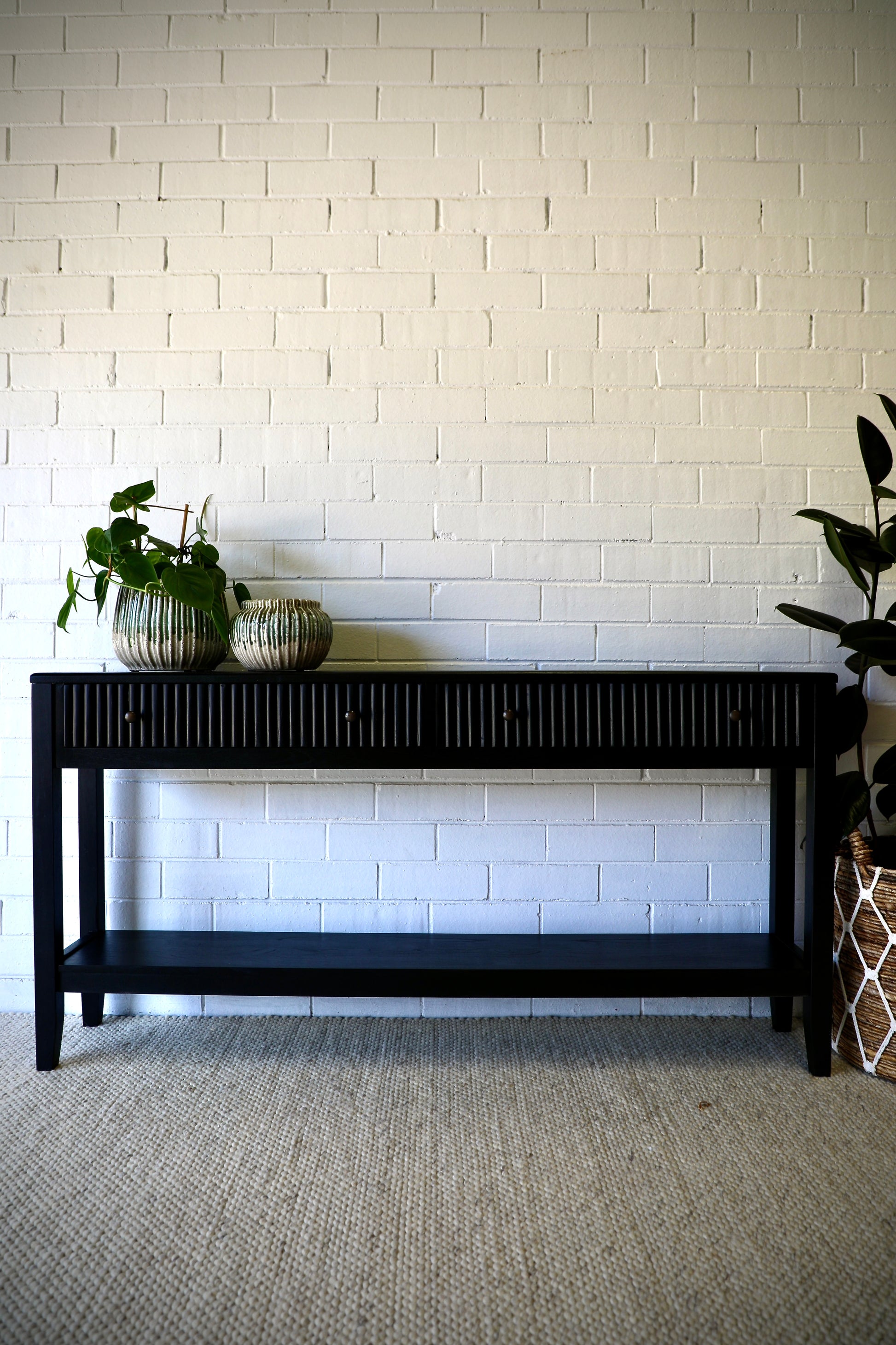 The Vienna - 2 Drawer Black 1500 Console brings a contemporary feel with its sleek design and textured drawer face. Built with sustainable white cedar its 2 drawers sit on wooden runners. Colour black. Measures 1500 length X 250 depth X 750 height. Styled.