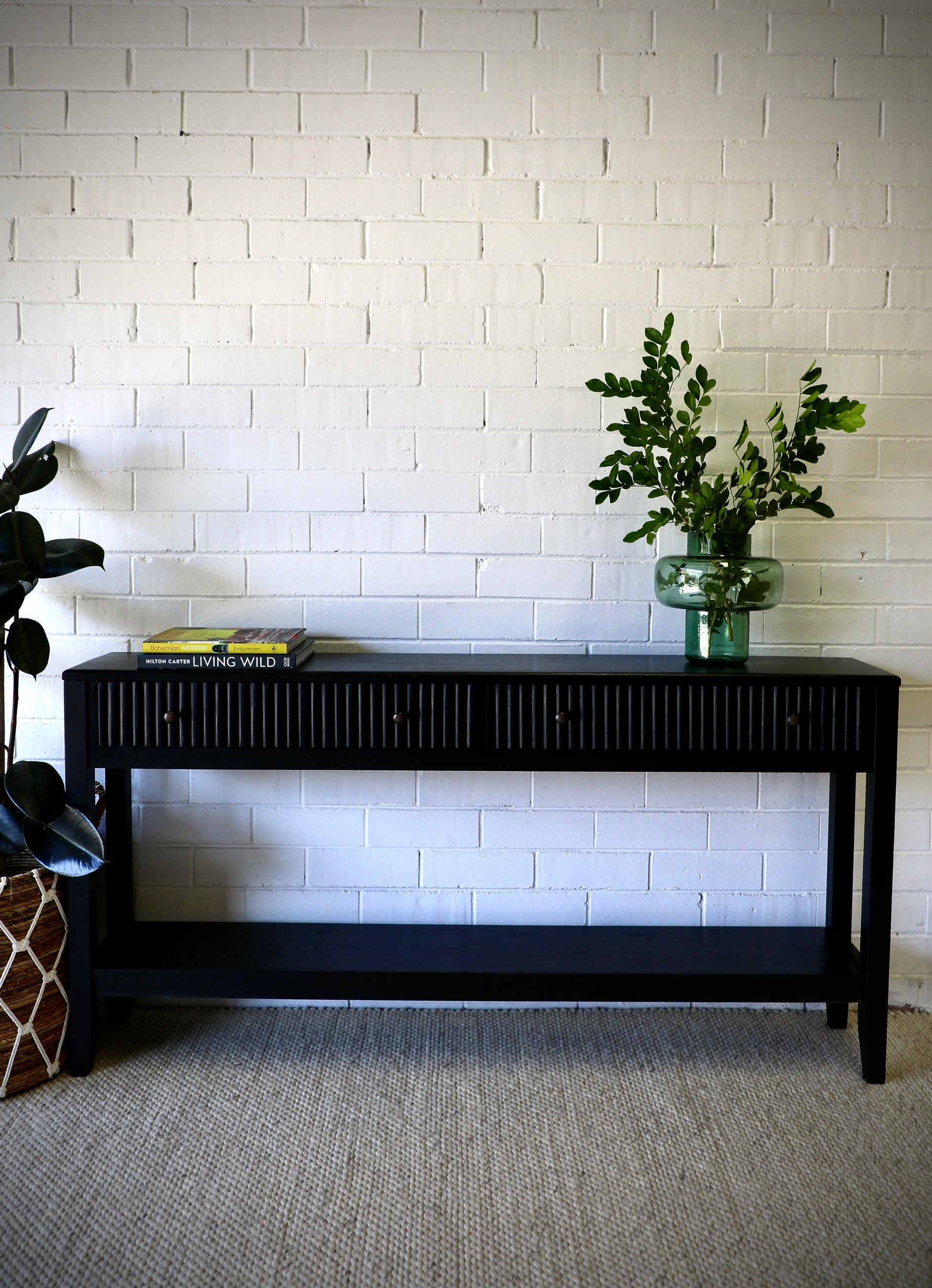 The Vienna - 2 Drawer Black 1800 Console brings a contemporary feel with its sleek design and textured drawer face. Built with sustainable white cedar its 2 drawers sit on wooden runners. Colour black. Measures 1800 length X 250 depth X 750 height. Styled.