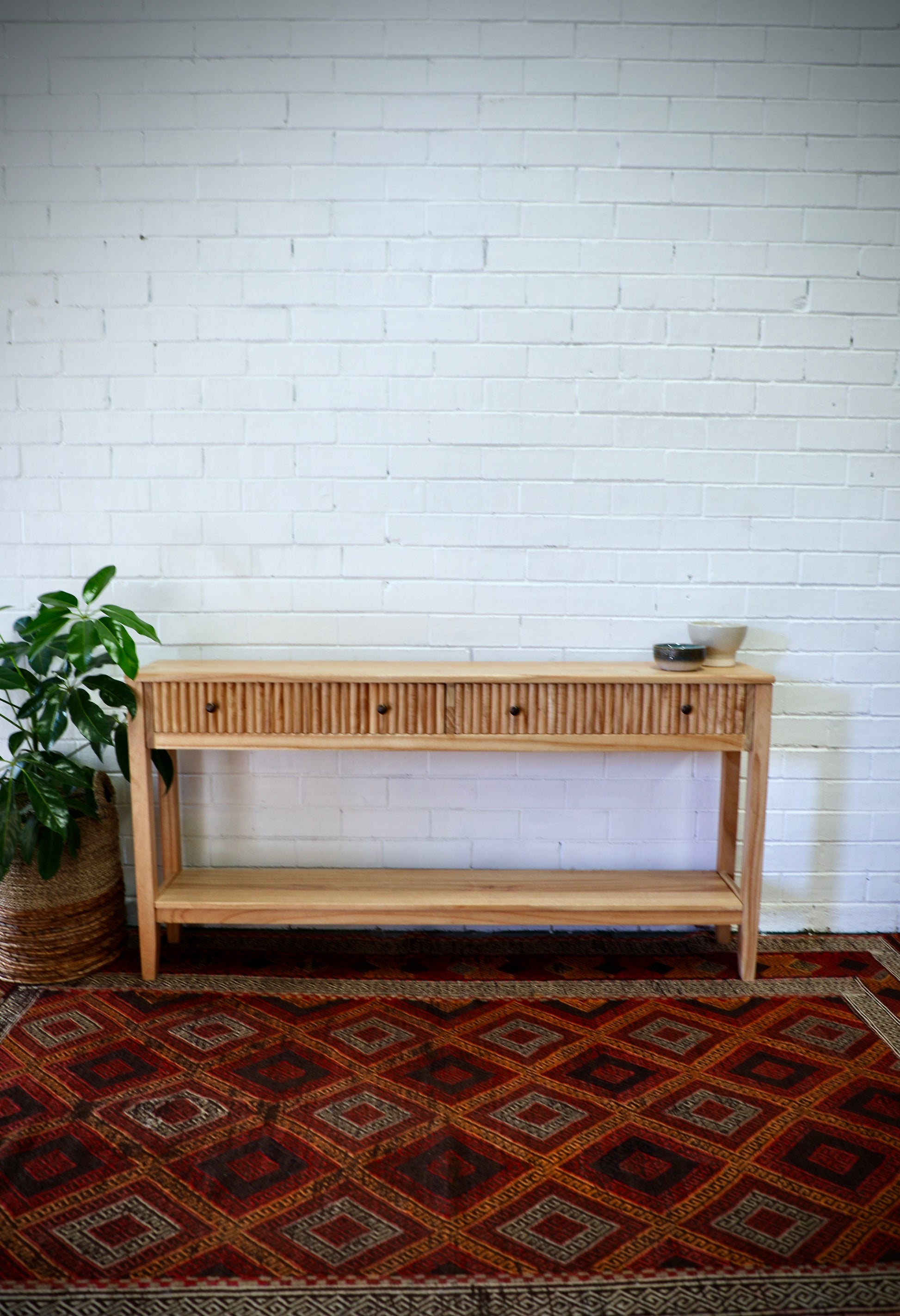 The Vienna - 2 Drawer Natural 1500 Console, natural, brings a contemporary feel with its sleek design and textured drawer face. Built with sustainable white cedar its 2 drawers sit on wooden runners. Colour natural. Measures 1500 length X 250 depth X 750 height. Styled.