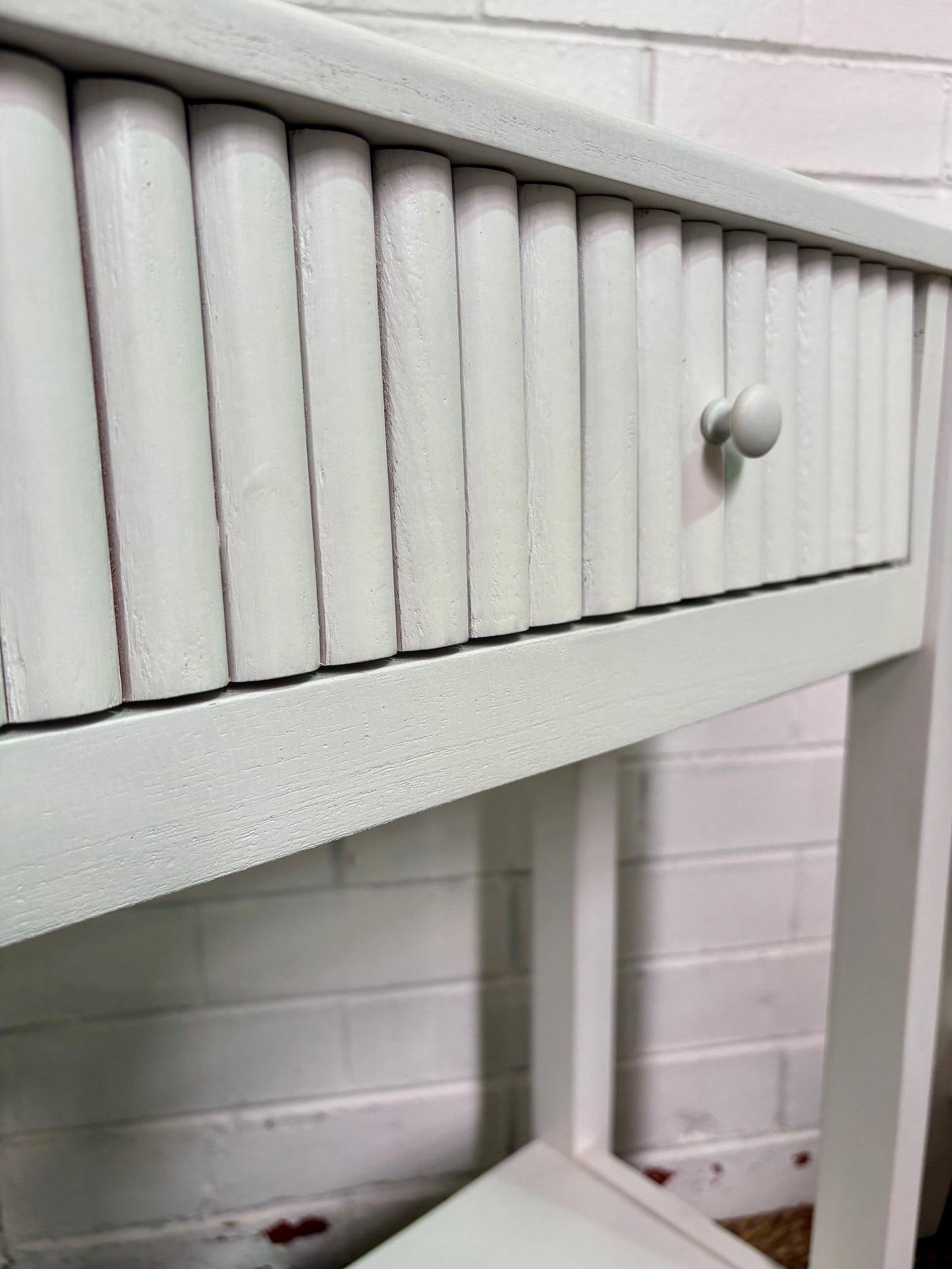 The Vienna - 2 Drawer White Console, natural, brings a contemporary feel with its sleek design and textured drawer face. Built with sustainable white cedar its 2 drawers sit on wooden runners. Colour white. Measures 1500 length X 250 depth X 750 height. Angle.