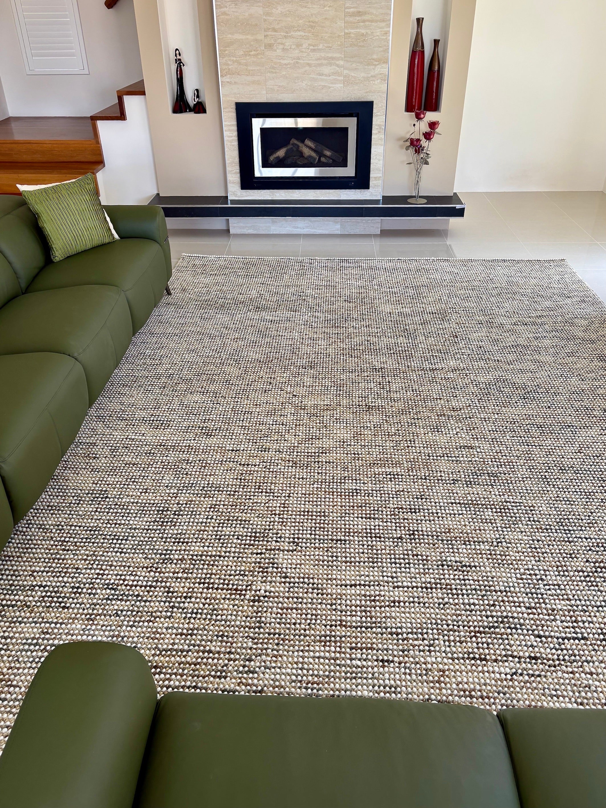 A wool hand woven textured rug styled in a modern Perth home living room setting.