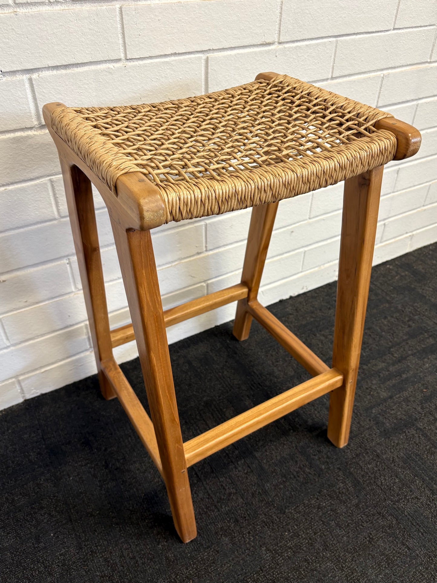 The Yakima Barstool boasts a coastal contemporary feel. Crafted from sustainable solid teak and featuring a luxurious synthetic rope seat. Colour natural. Measures 400 wide X 340 depth X 670 seat height. Side Angle.