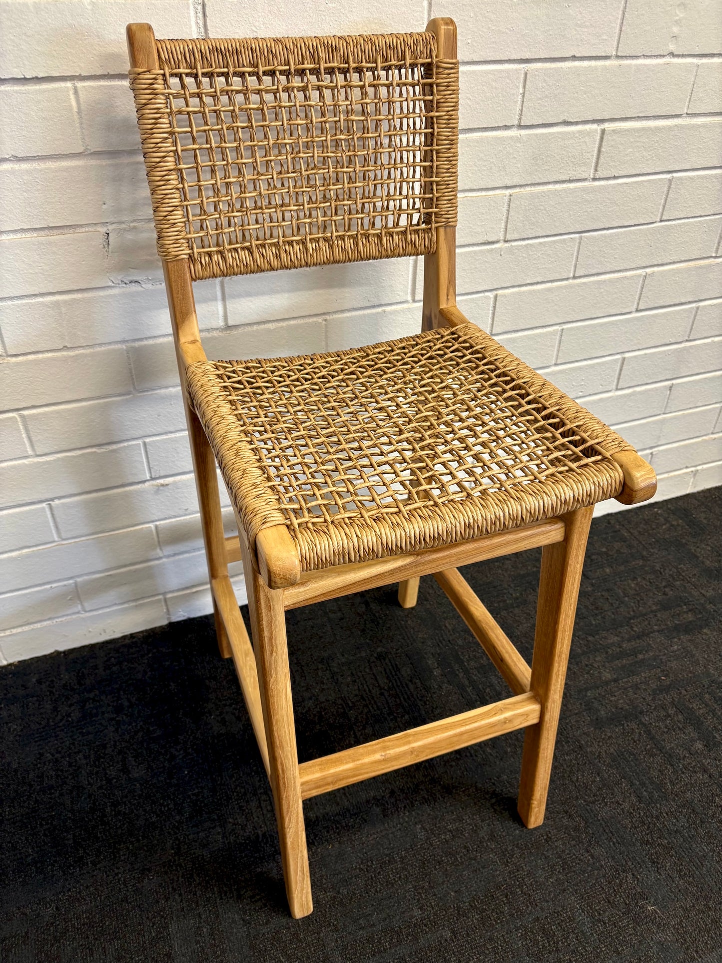The Yakima with Back Barstool boasts a coastal contemporary feel. Crafted from sustainable solid teak and featuring a luxurious synthetic rope seat and back. Colour natural. Measures 400 wide X 500 depth X 670 seat height. Back height 1020. Angle.