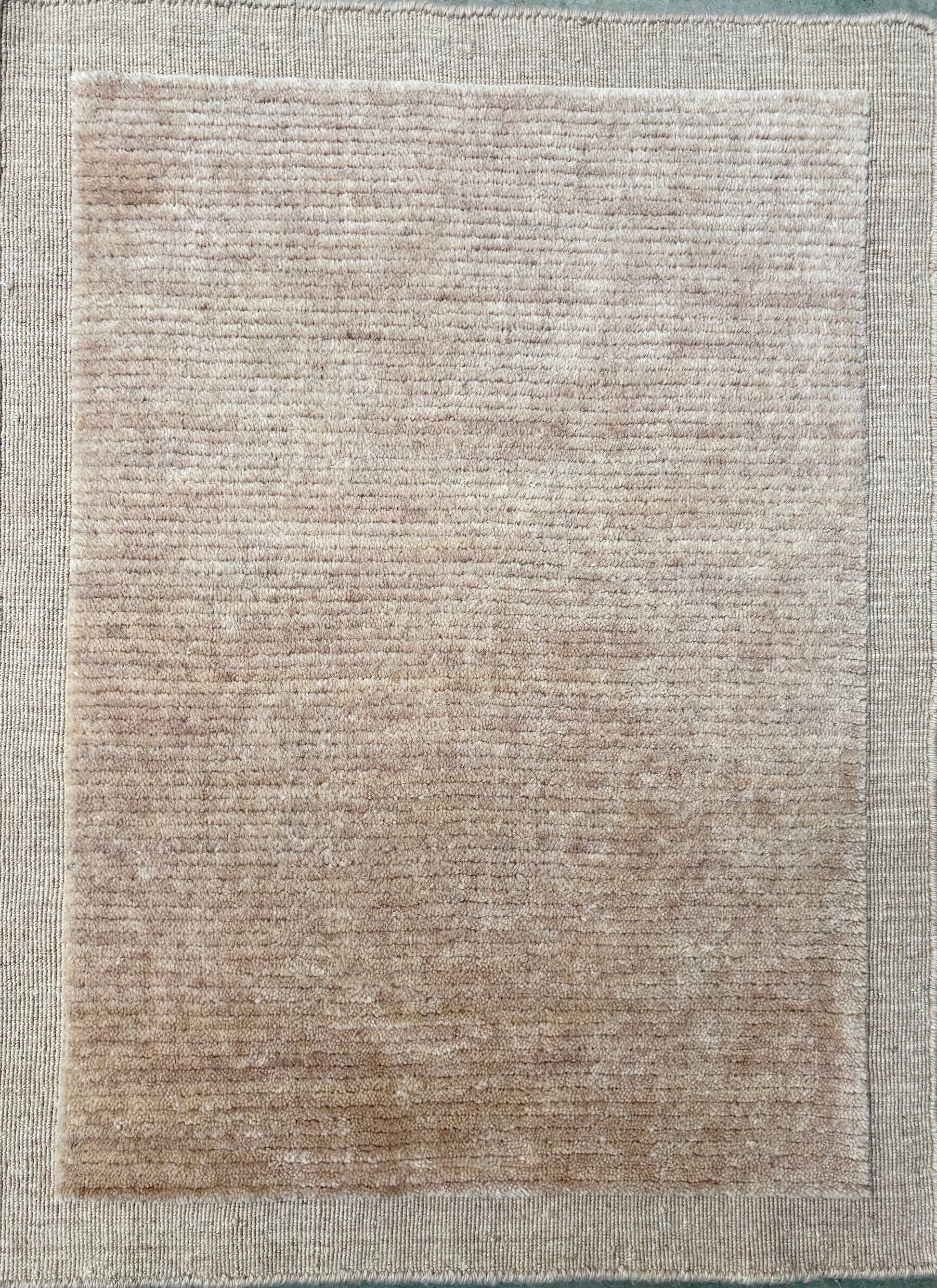 Yarra Latte hand-woven wool rug in a soft milky neutral tone with a low channeled pile and flat woven border. Available in 4 sizes. Top View.