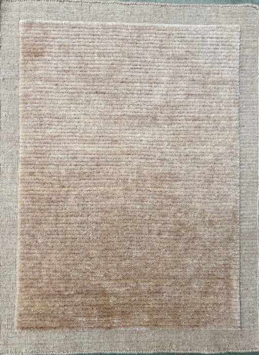 Yarra Latte hand-woven wool rug in a soft milky neutral tone with a low channeled pile and flat woven border. Available in 4 sizes. Top View.