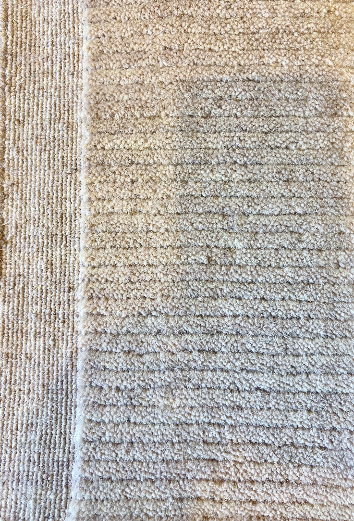 Close-up of the Yarra Latte wool rug showing the low channeled pile texture and flat woven border edge. Available in 4 sizes. Close View.