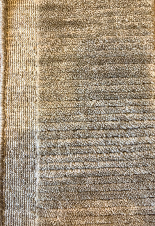 Close-up of the Yarra Moss piled wool rug showing the low channeled pile texture and flat woven border edge. Available in 4 sized. Close view.
