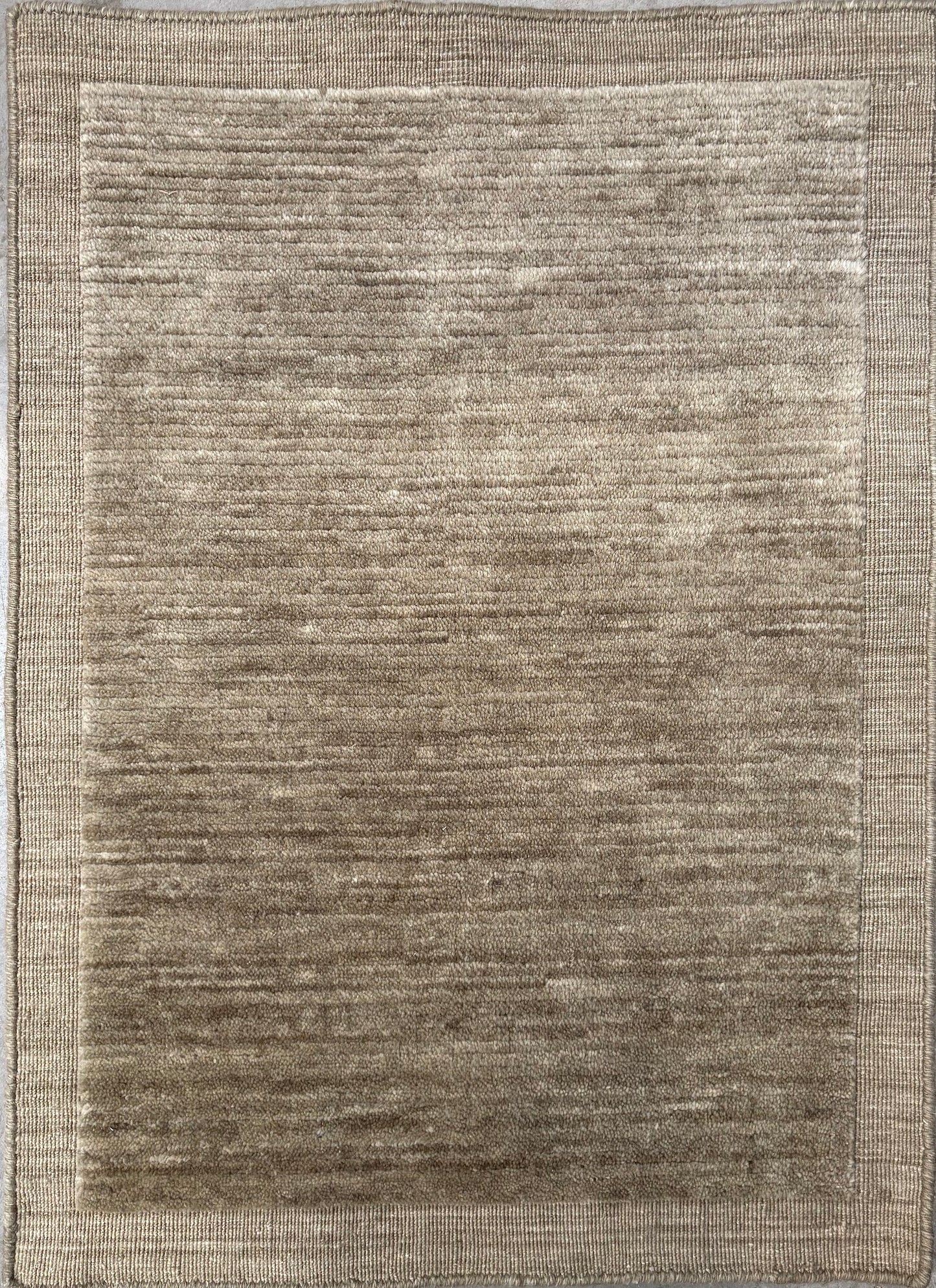 Yarra Moss piled hand-woven wool rug in a muted earthy green with a low channeled pile and flat woven border. Available in 4 sizes. Top View.