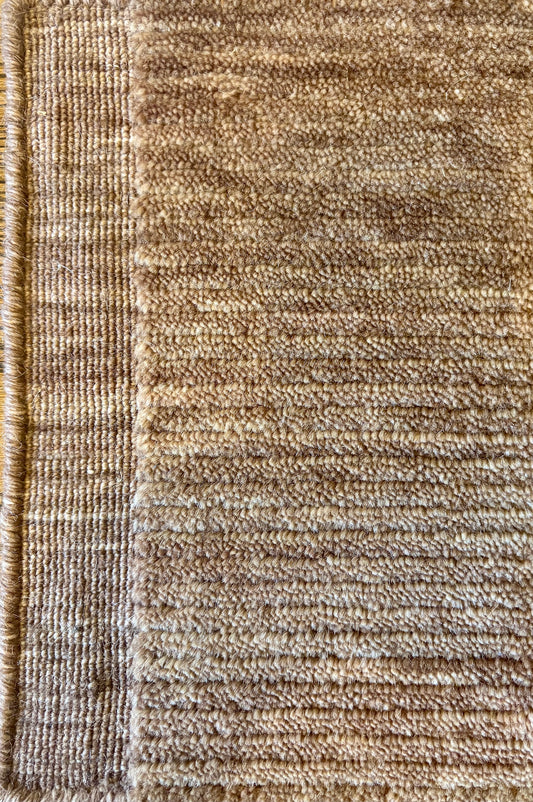 Close-up of the Yarra Rust piled wool rug showing the low channeled pile texture and flat woven border edge. Available in 4 sized. Close view.
