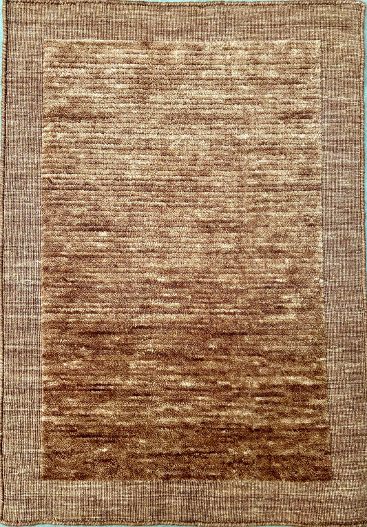 Yarra Rust piled hand-woven wool rug in a warm earthy terracotta tone with a low channeled pile and flat woven border. Available in 4 sizes. Top View.