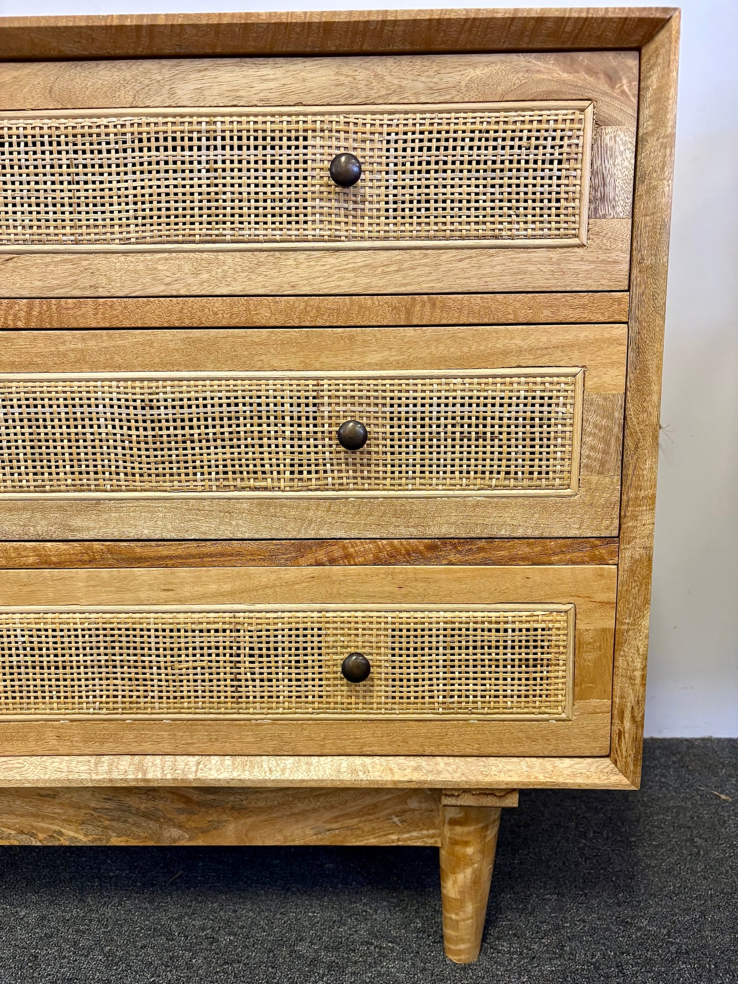 The Yosemite 3 Drawer chest features a solid white cedar frame and drawers.  Open mesh rattan drawer face with drawers on wooden runners. stylish turned legs. Measures 850W x 450D x 750H. Side.