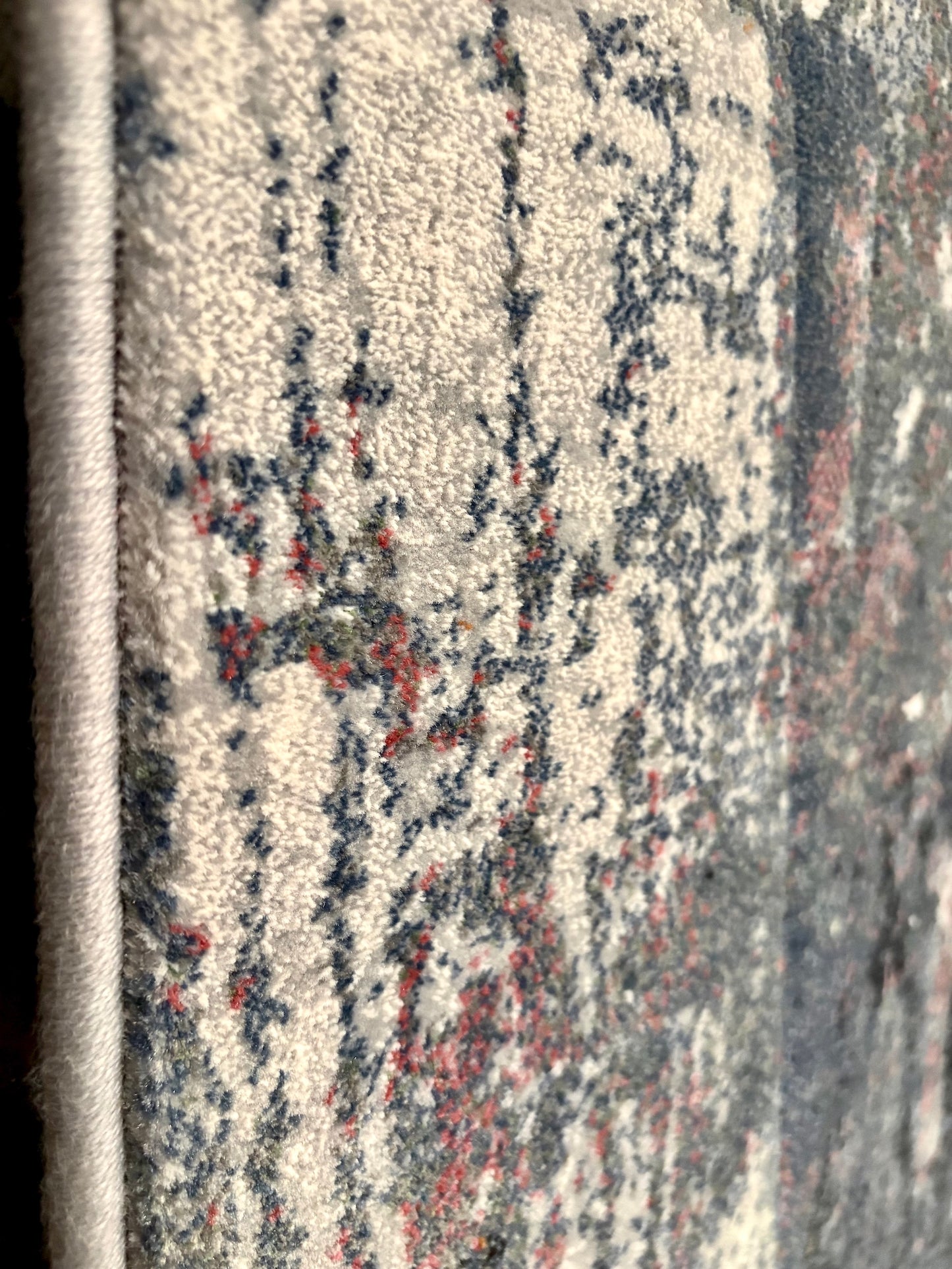 The Zenith Flux rug. Skilfully crafted from durable heat-set polypropylene, this rug features a chic contemporary design. Colours, greys, white, beige, blues. 3 Sizes. Side Close.