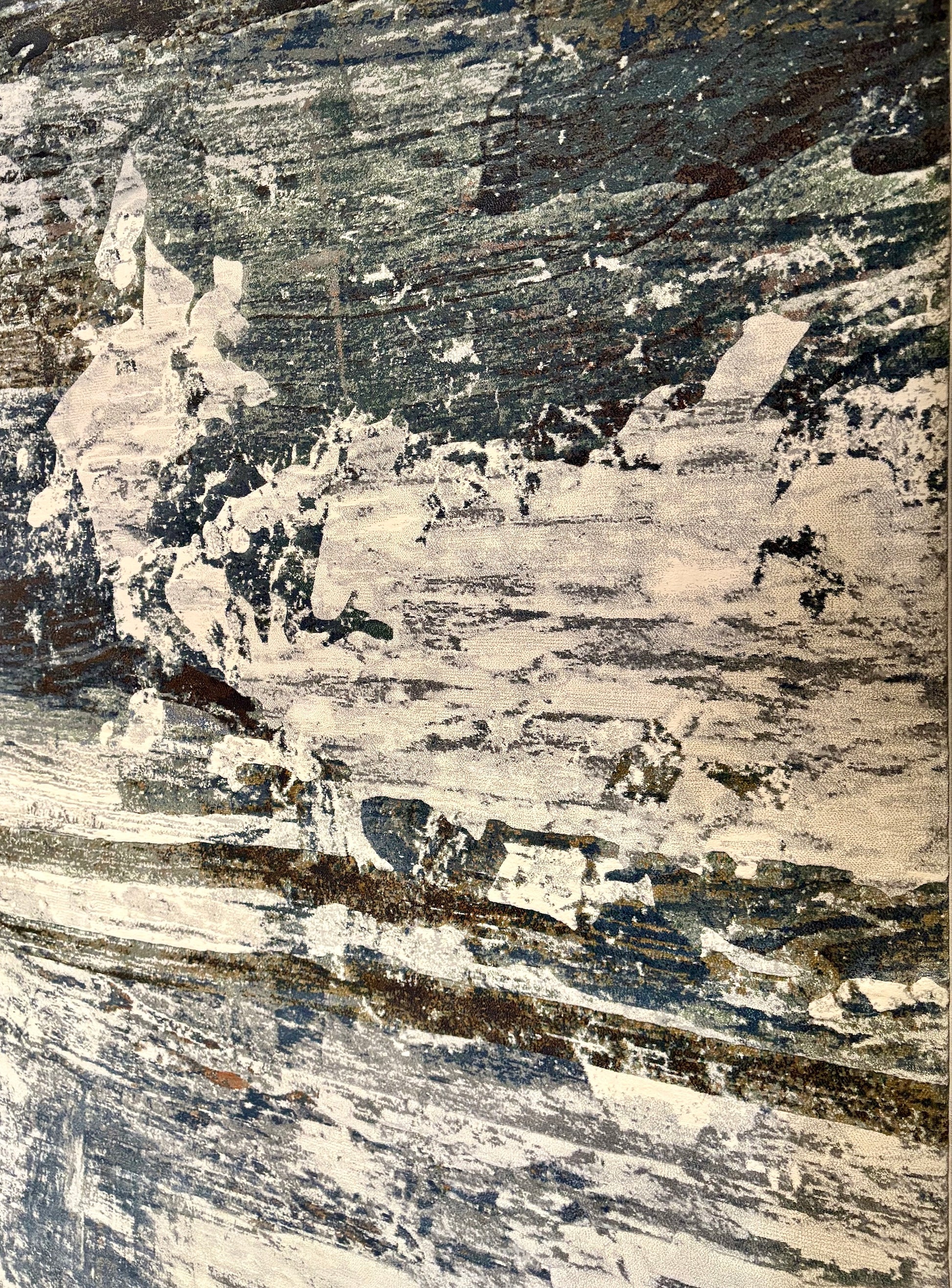 The Zenith Strata rug. This rug is skilfully created from strong heat-set polypropylene, showcasing a stylish contemporary design. Colours, whites, greys, blues, beiges. Angle.