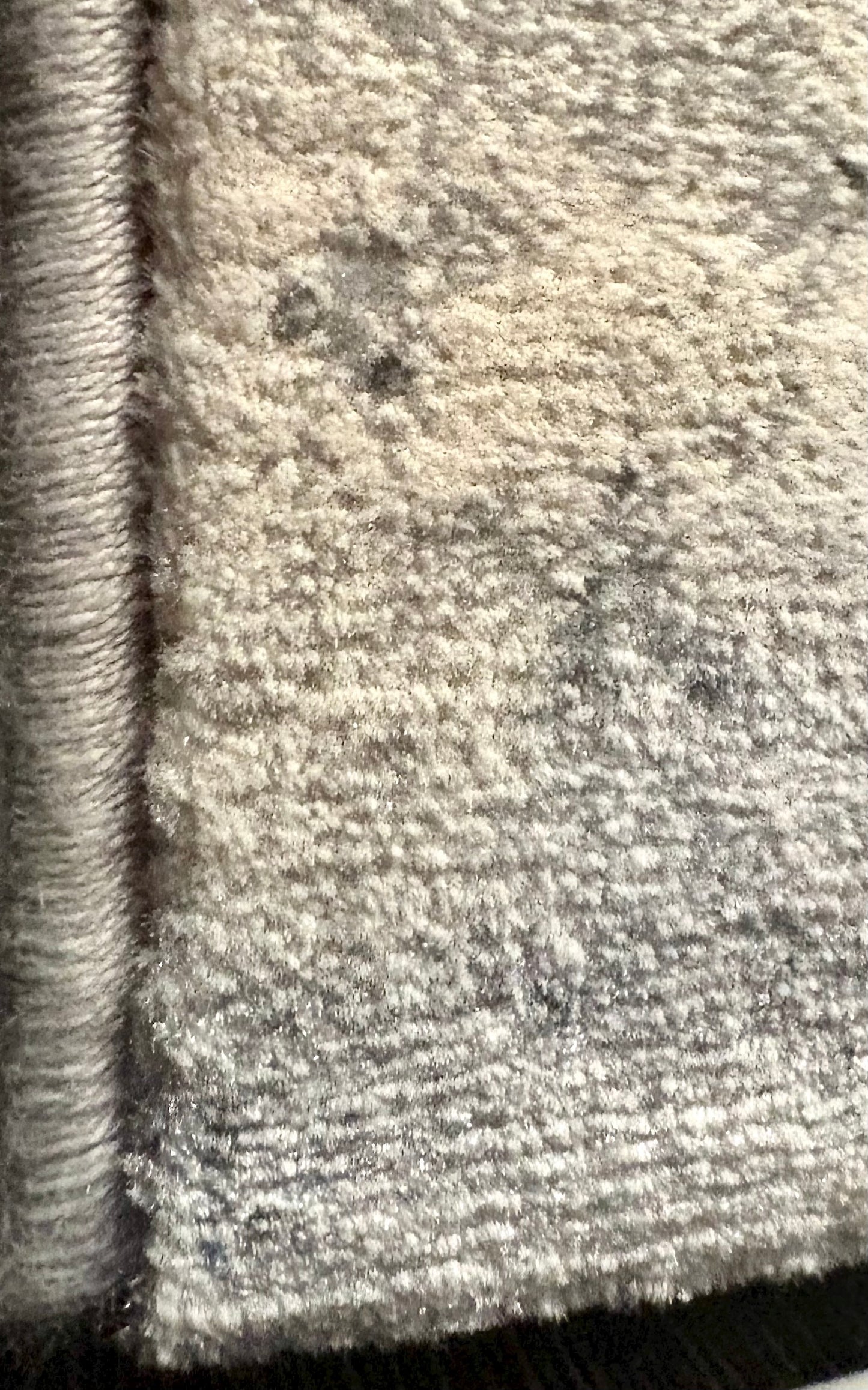 The Zenith Strata rug. This rug is skilfully created from strong heat-set polypropylene, showcasing a stylish contemporary design. Colours, whites, greys, blues, beiges. Corner.