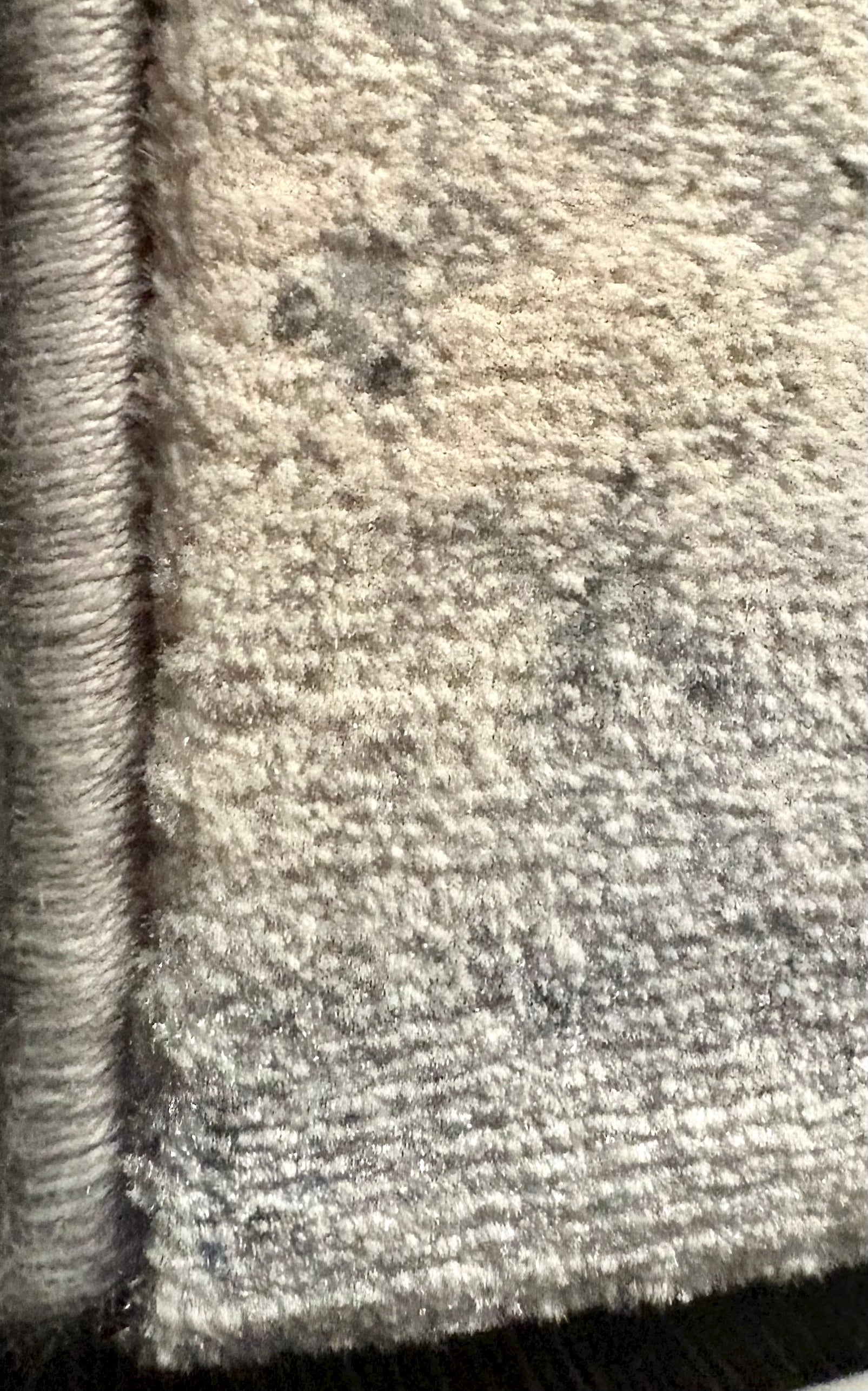 The Zenith Strata rug. This rug is skilfully created from strong heat-set polypropylene, showcasing a stylish contemporary design. Colours, whites, greys, blues, beiges. Corner.