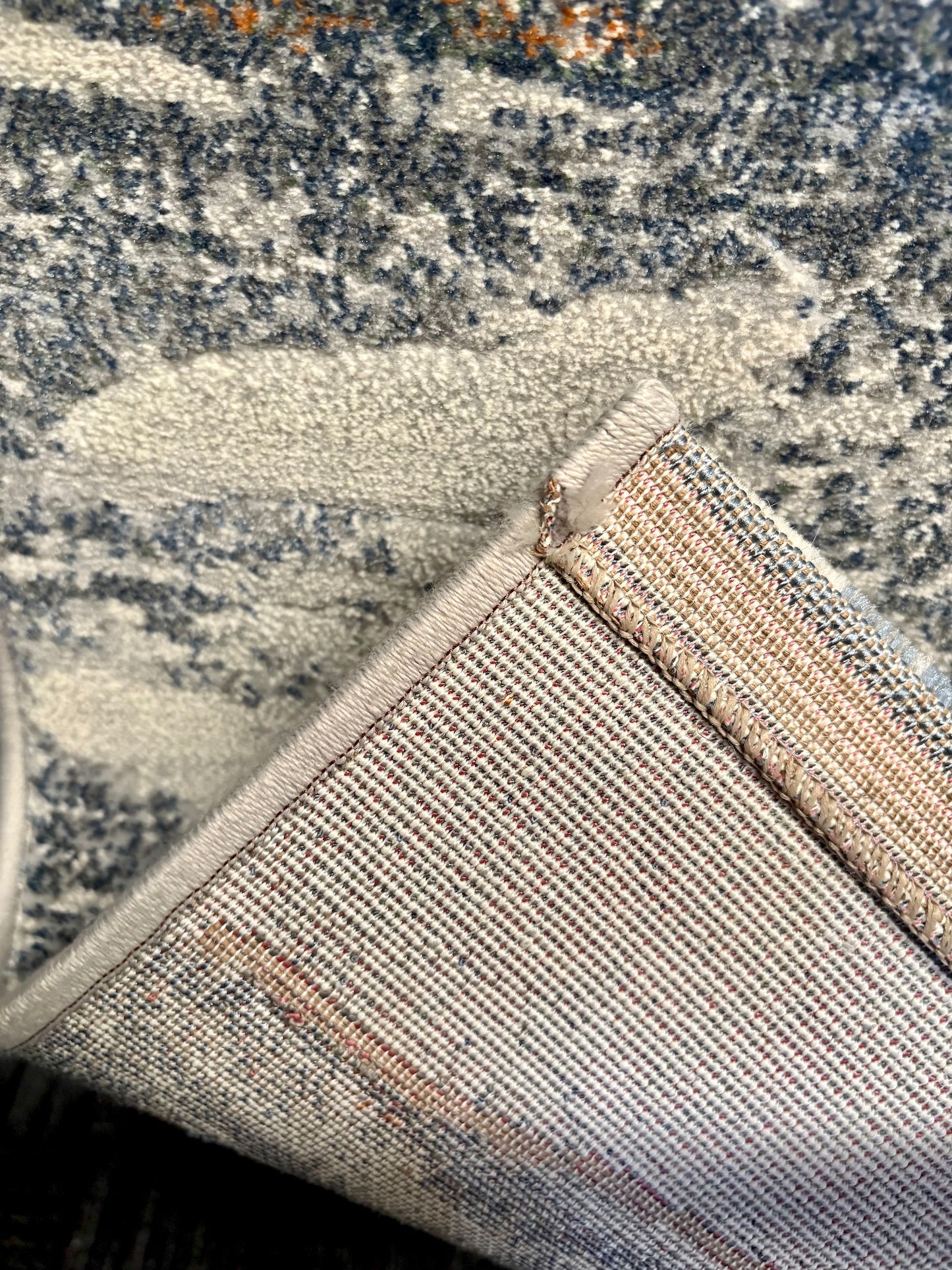 The Zenith Terrain rug. This rug is skilfully crafted from heat-set polypropylene, showcasing a stylish contemporary design. Colours, whites, blues beiges, dark greys. Fold.