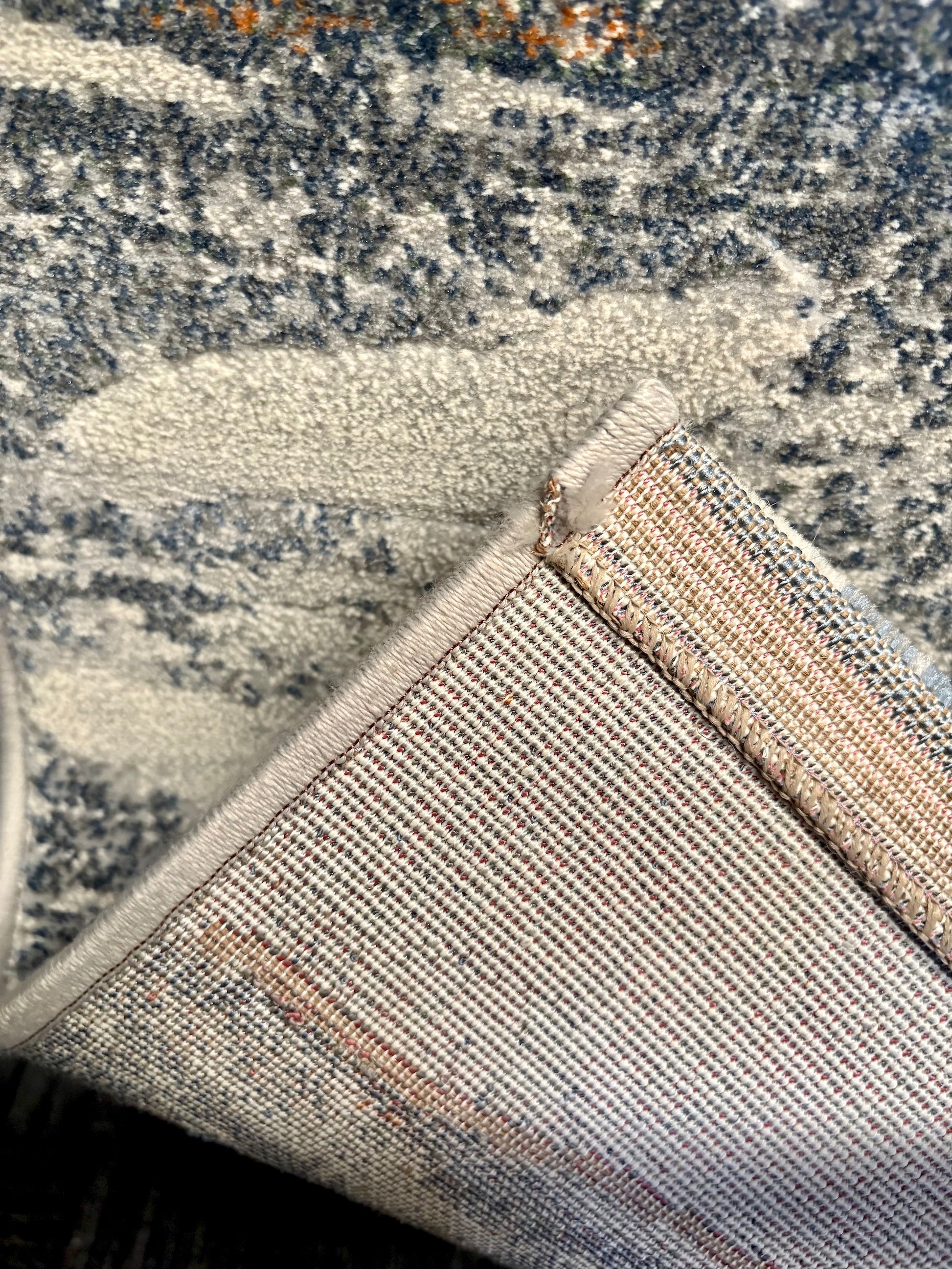 The Zenith Terrain rug. This rug is skilfully crafted from heat-set polypropylene, showcasing a stylish contemporary design. Colours, whites, blues beiges, dark greys. Fold.