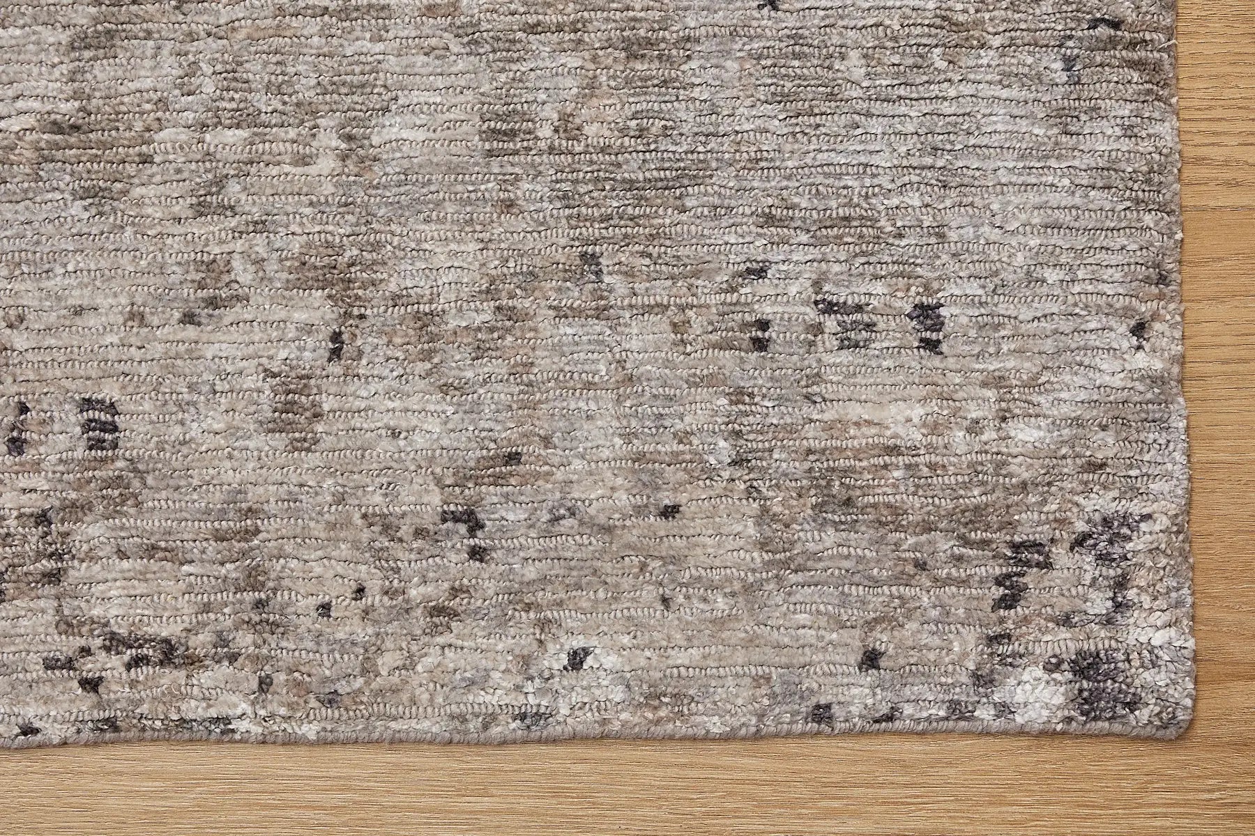 Zurich Smoke is a luxurious contemporary/modern designed rug.  Hand Knotted from a blend of wool and bamboo Silk. Colours Dark Grey, Grey, and Light Greys. Sizes 200 X 290, 250 X 300 and 270 X 360. Corner.