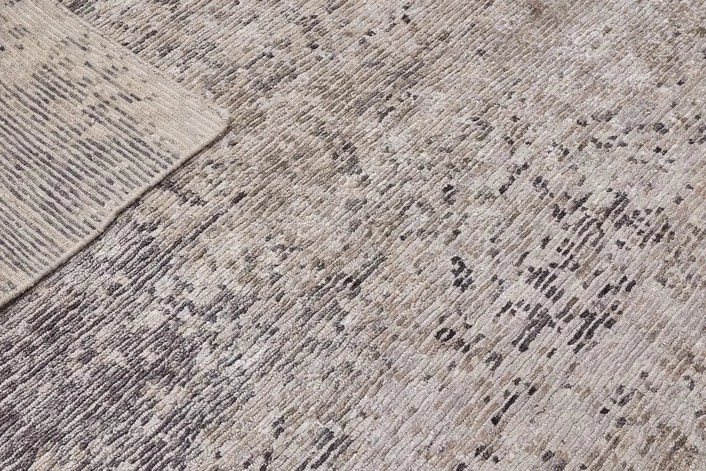 Zurich Smoke is a luxurious contemporary/modern designed rug.  Hand Knotted from a blend of wool and bamboo Silk. Colours Dark Grey, Grey, and Light Greys. Sizes 200 X 290, 250 X 300 and 270 X 360. Fold.
