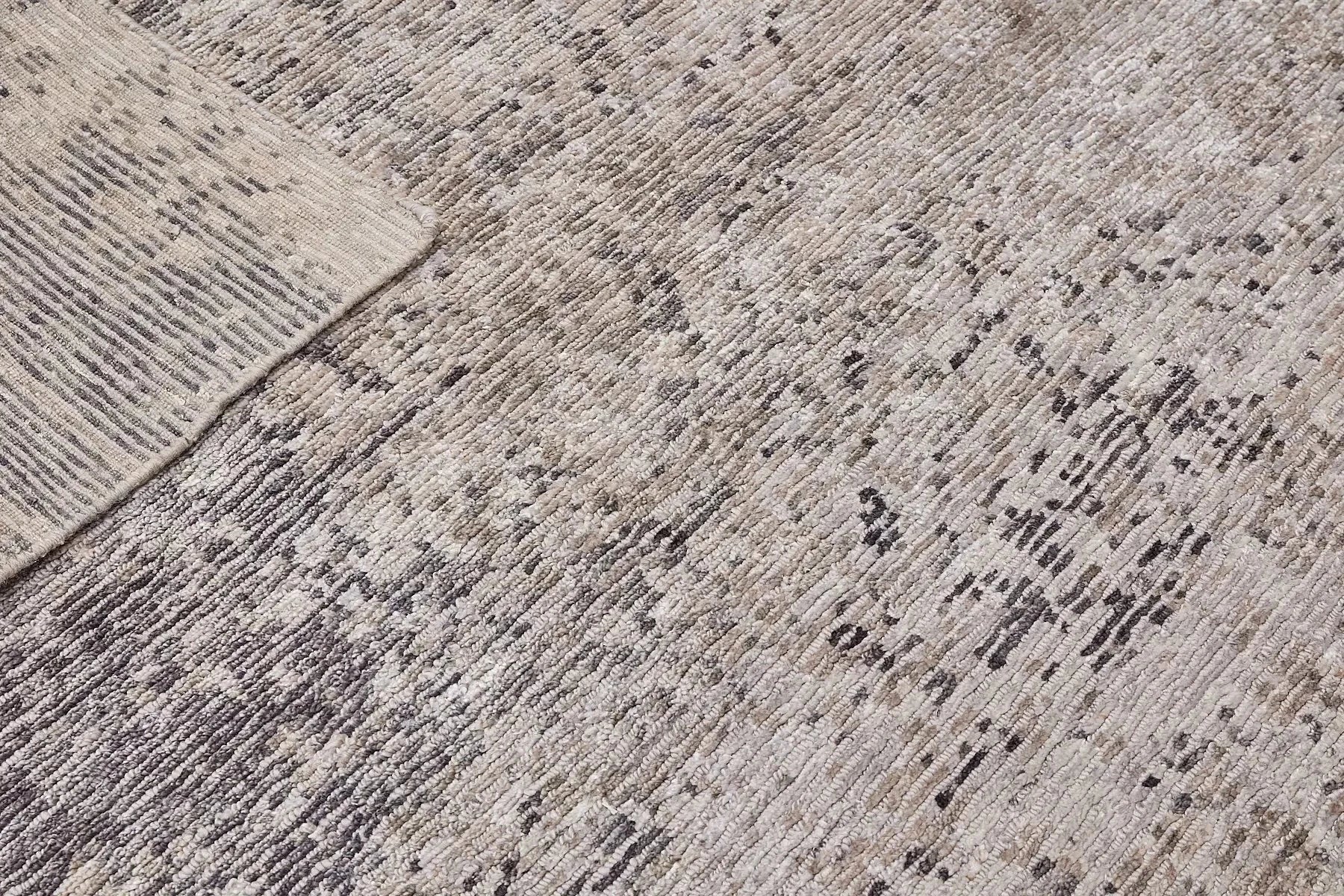Zurich Smoke is a luxurious contemporary/modern designed rug.  Hand Knotted from a blend of wool and bamboo Silk. Colours Dark Grey, Grey, and Light Greys. Sizes 200 X 290, 250 X 300 and 270 X 360. Fold.