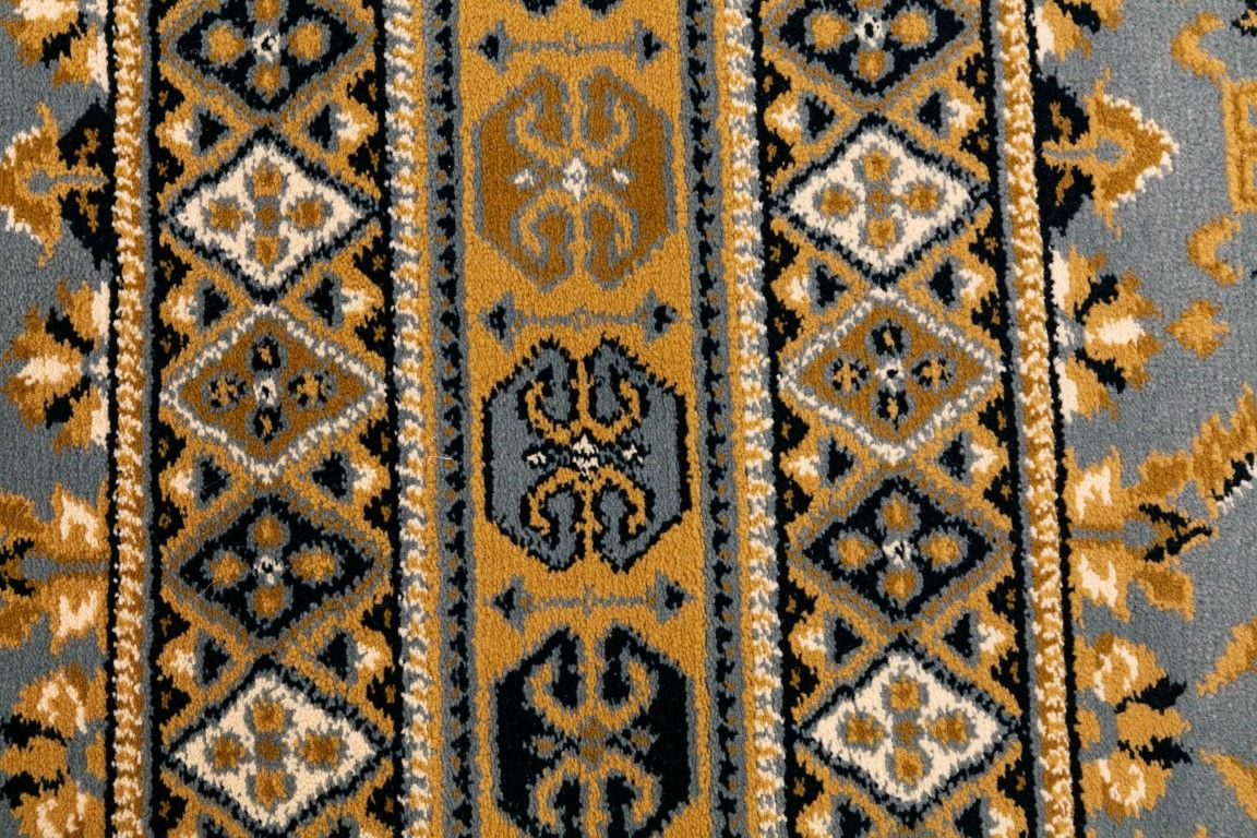 Afghan Wedgwood Blue is a machine made rug featuring traditional afghan tribal designs.  Made from  heat-set polypropylene. Colours Blues, Reds, Golds, and Blacks.  Sizes. 160 X 235, 200 X 285, 240 X 340 and 300 X 400. Close.