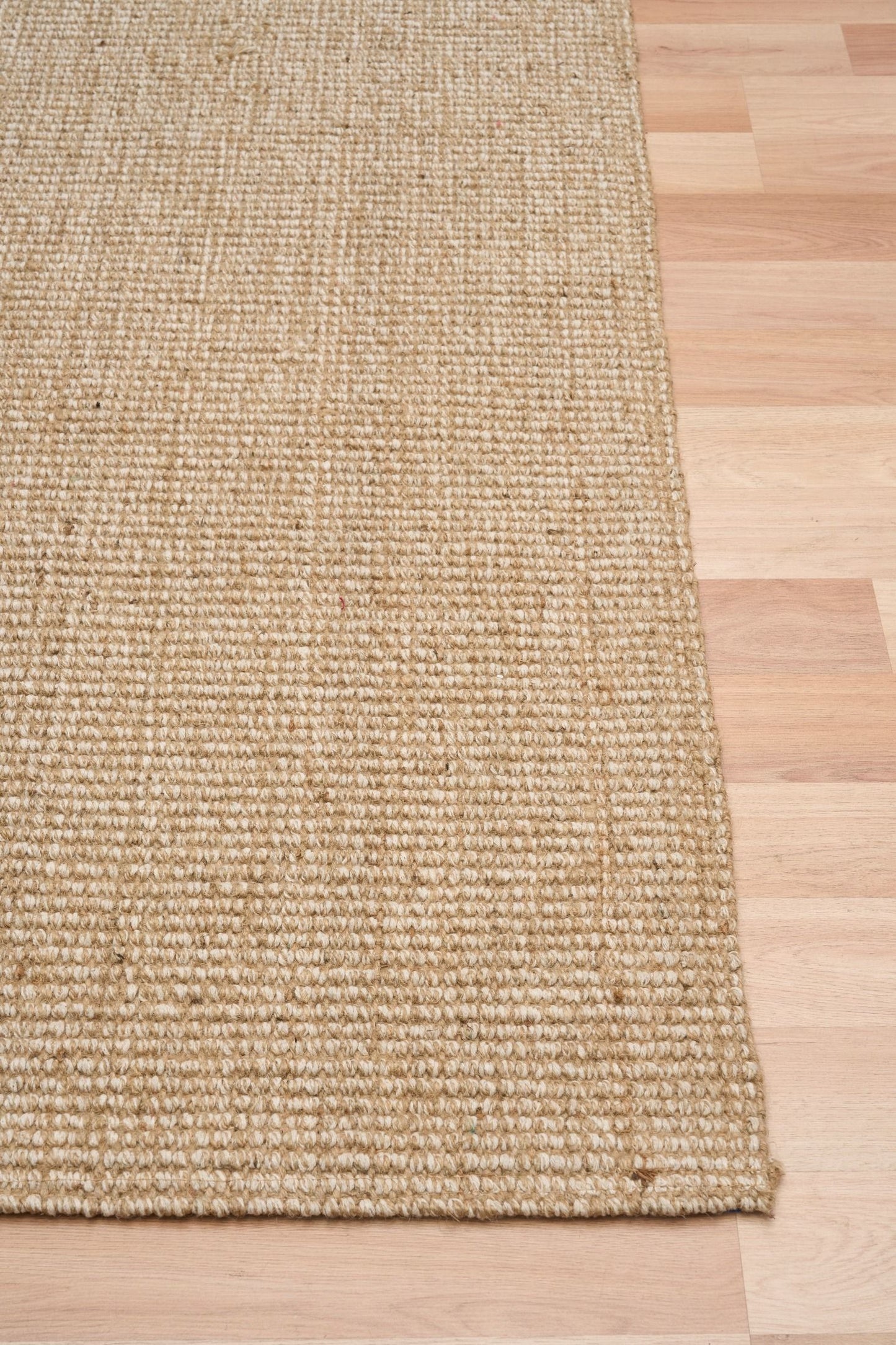 Waves, a hand woven jute rug with natural, neutral colours. 3 sizes. Corner.