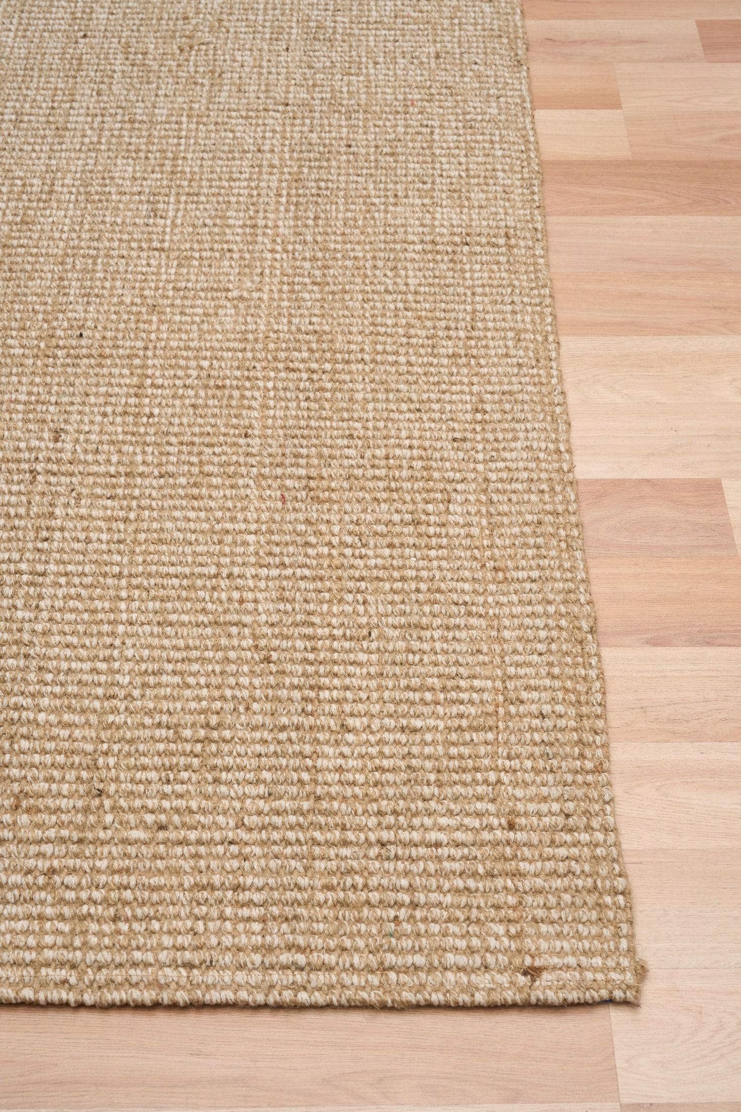 Waves, a hand woven jute rug with natural, neutral colours. 3 sizes. Corner.