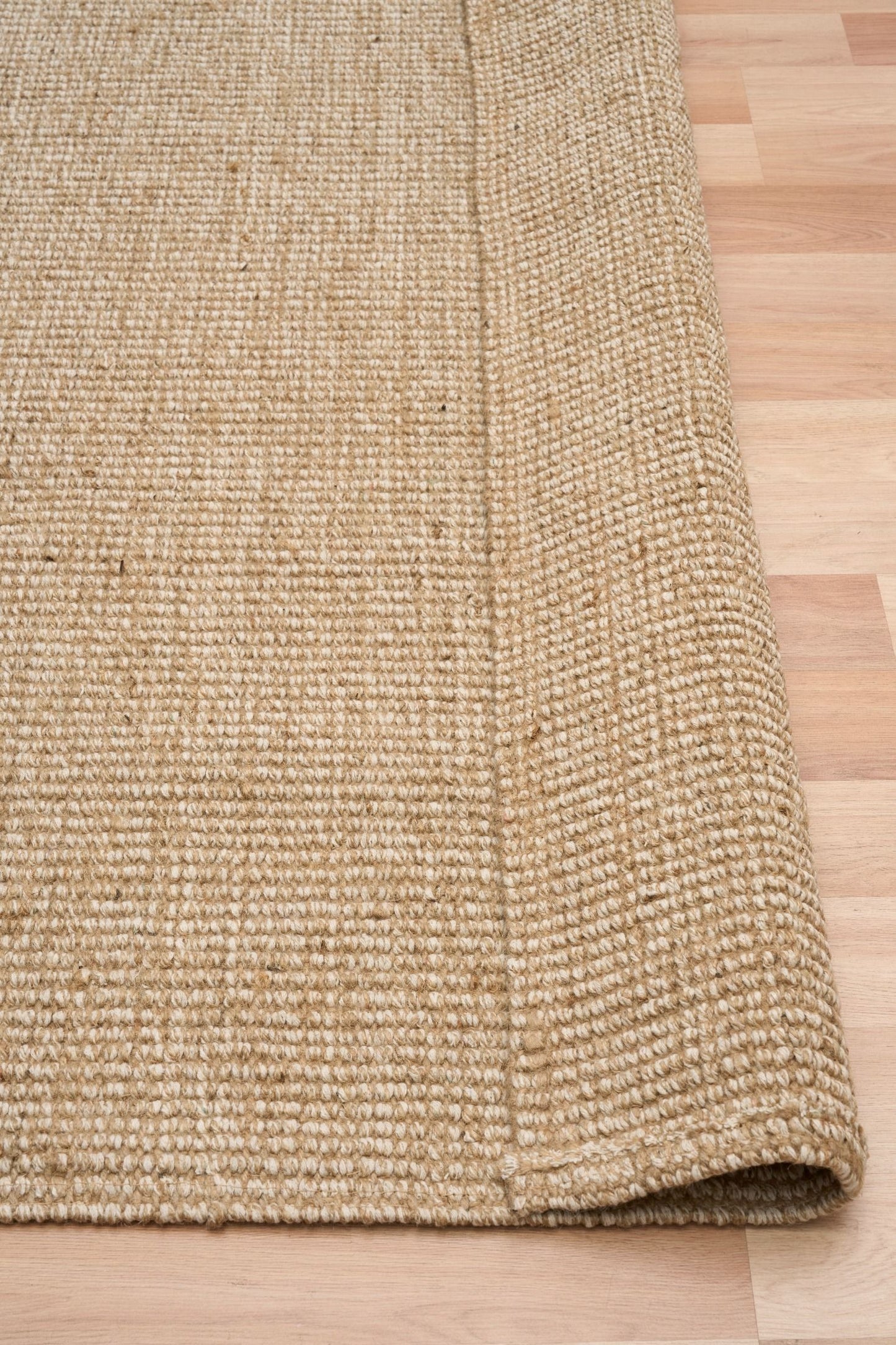 Waves, a hand woven jute rug with natural, neutral colours. 3 sizes. Fold.